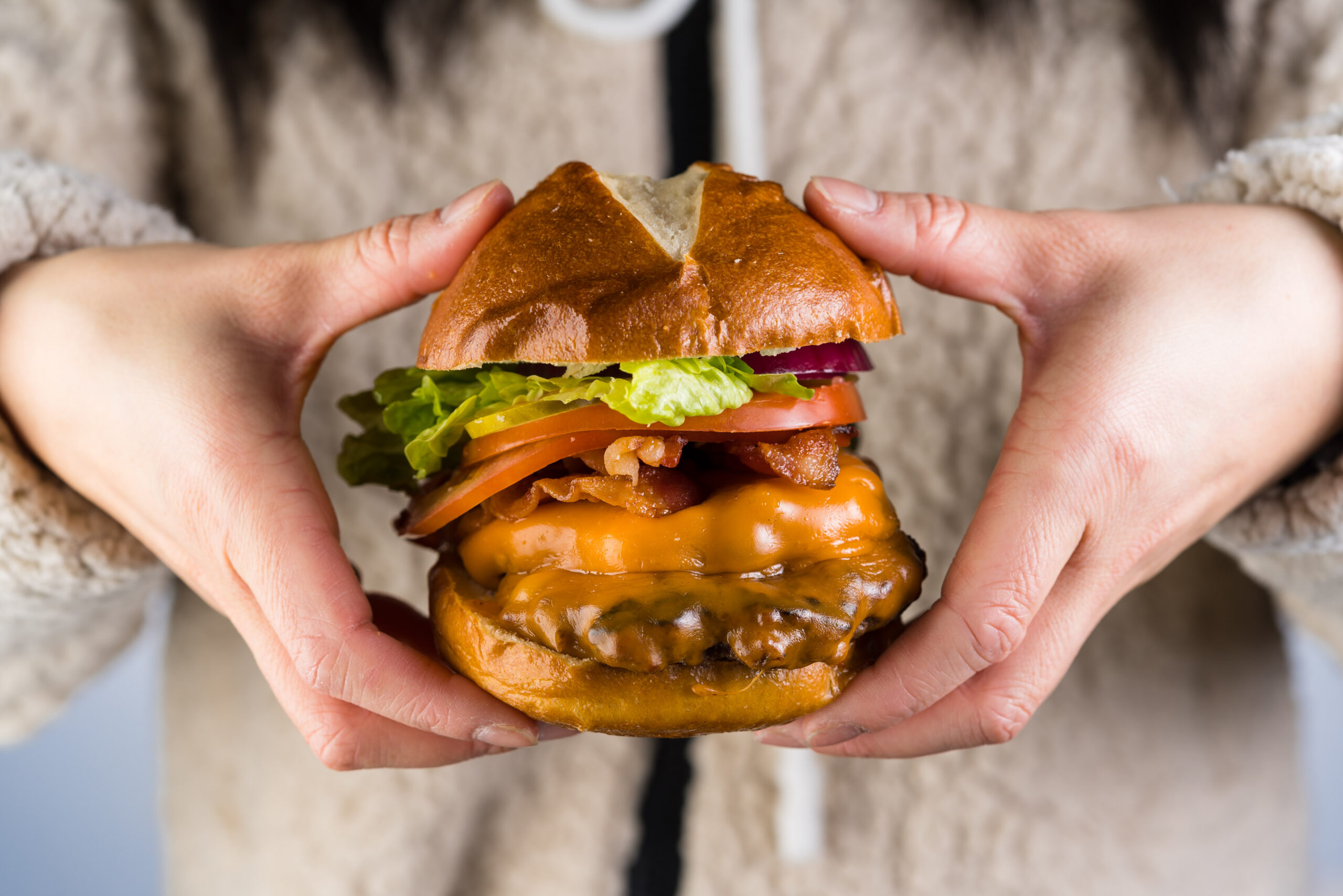 AllStar Wings & Ribs burger in person's hands